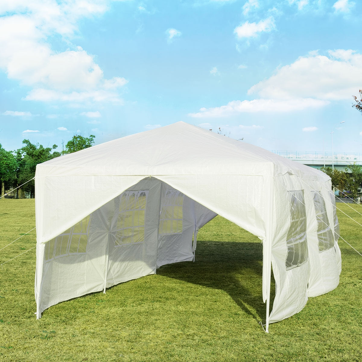 White canopy tent on a lawn with a front opening and windowed sidewalls.