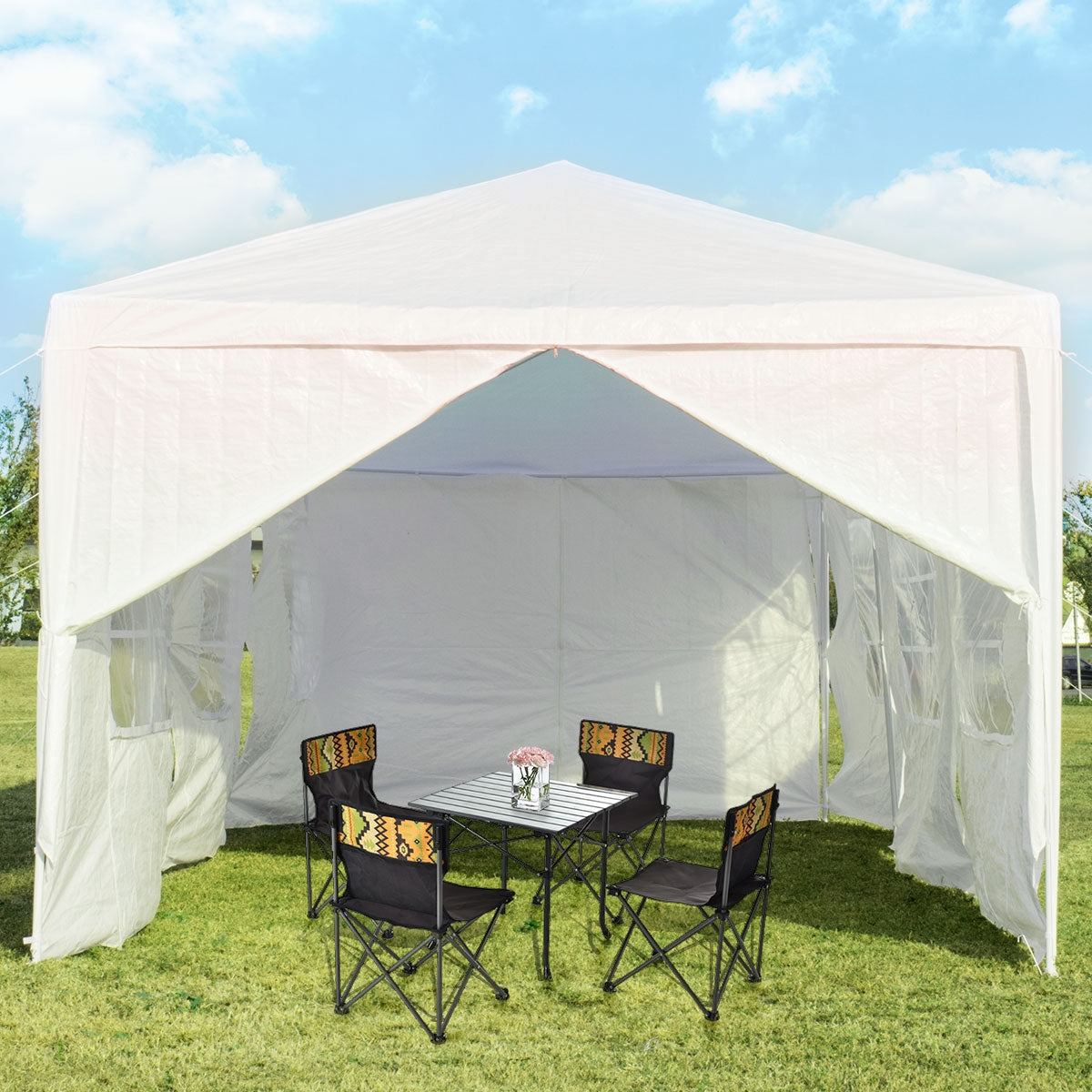 White canopy tent with its front panels parted, revealing a table and four chairs inside.