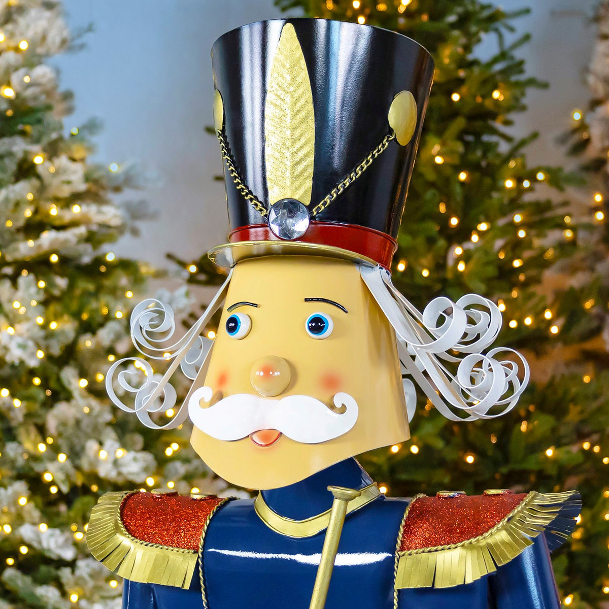 Close-up of the nutcracker's face, white curled hair and tall black-and-gold hat