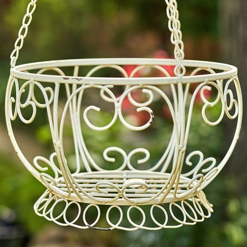 Close view of the cream basket’s curled iron scrollwork, rim, and circular base.