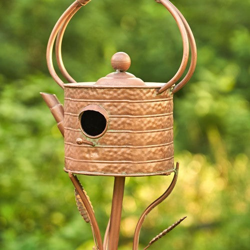 Close-up of the antique copper teapot birdhouse entry hole and spout