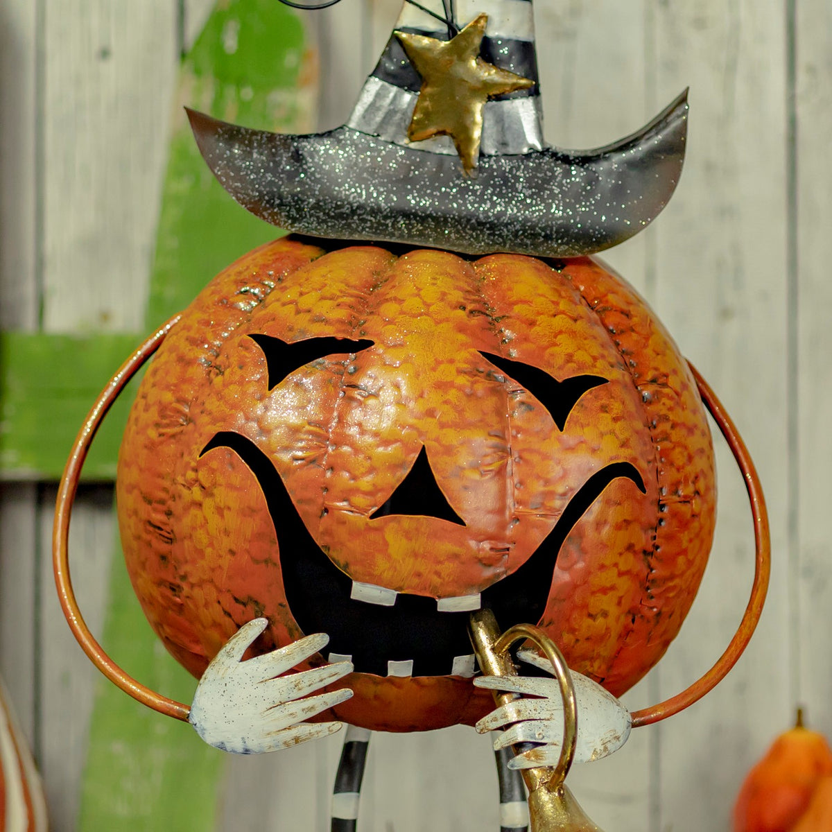 Close-up of the orange jack-o'-lantern face with glittered hat brim