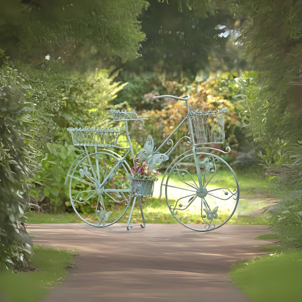 Green bicycle-shaped plant stand with empty baskets and a flower-filled center basket on a garden path.