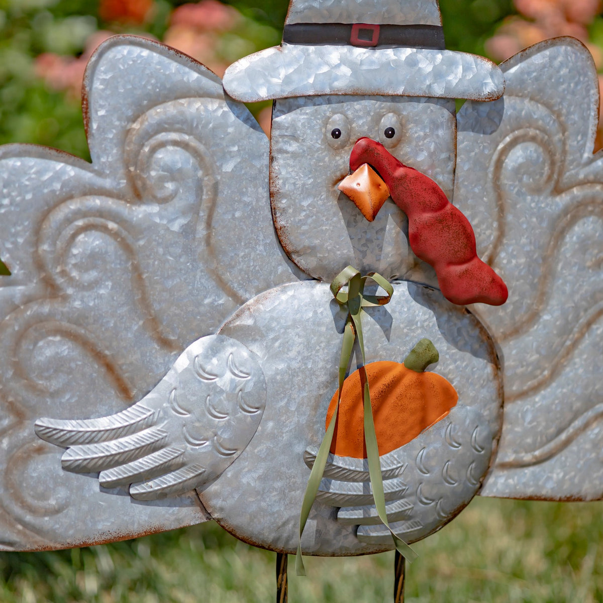 Close view of the turkey stake’s face, red wattle, bow, orange breast and embossed feather details.