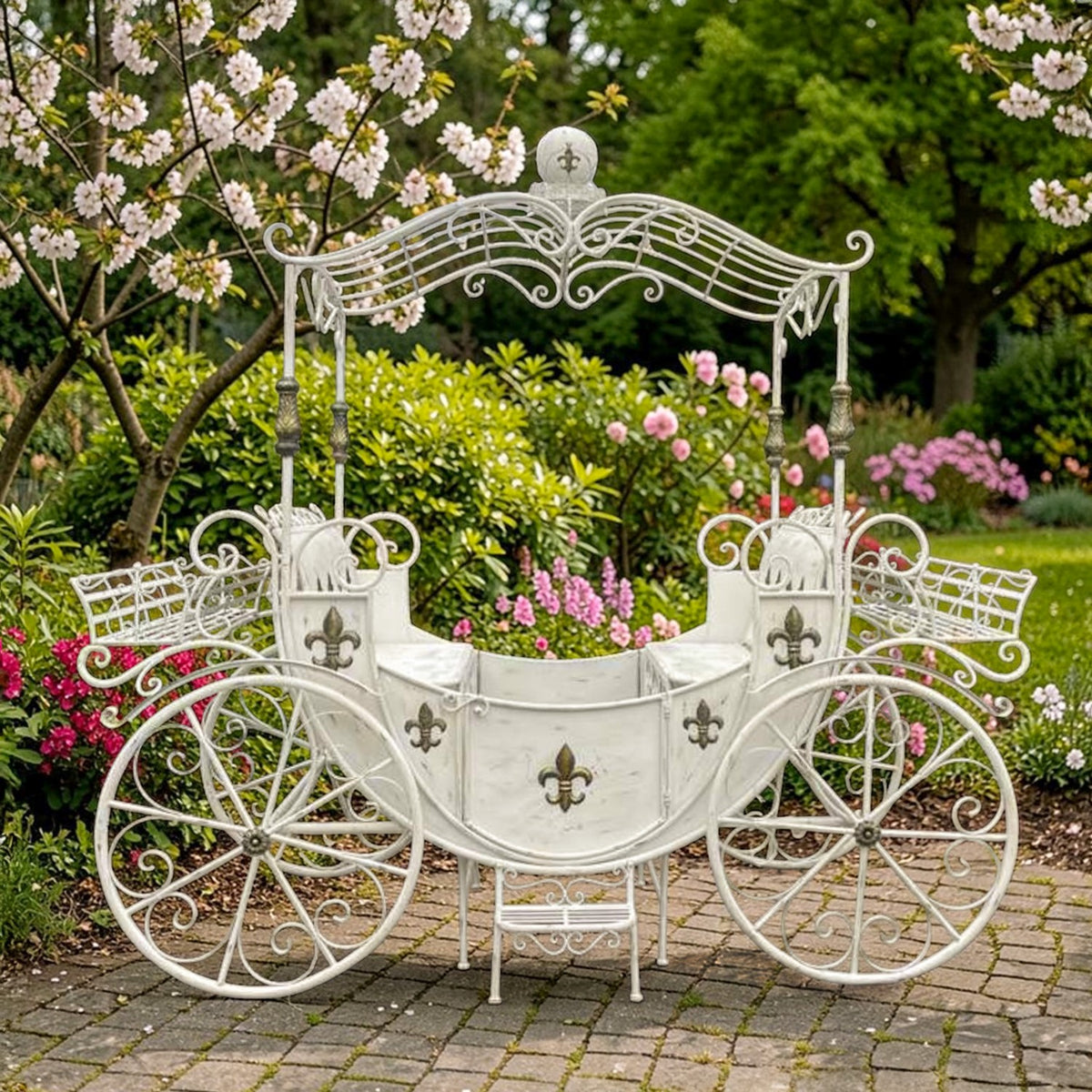 Antique white iron carriage with fleur-de-lis details, shown from the front in a garden