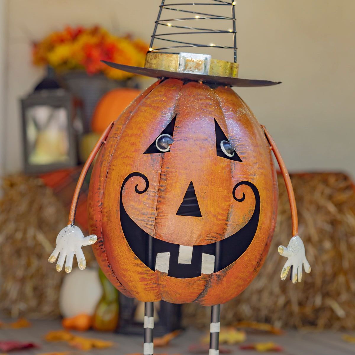Close-up of the orange jack-o'-lantern face, hat brim and painted details
