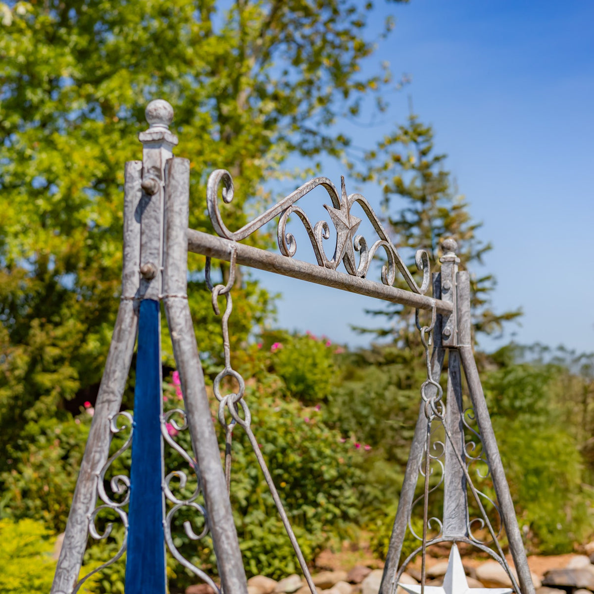 Close view of the distressed iron swing frame and decorative star details