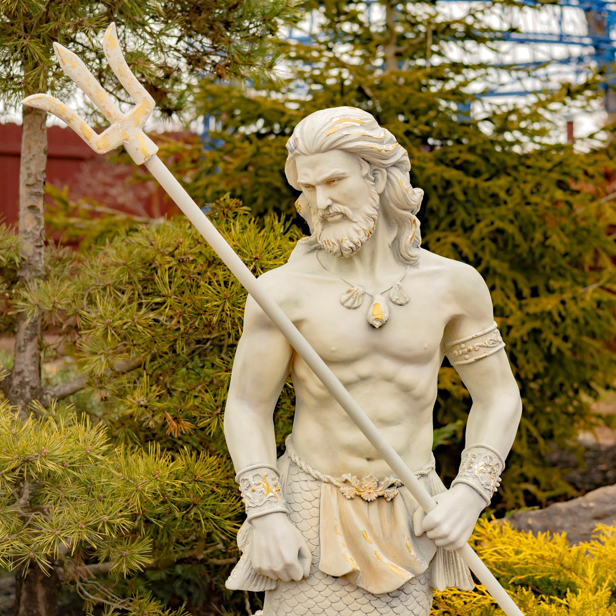 Closer view of the merman’s face, jewelry, and upper body as he grips a long trident.