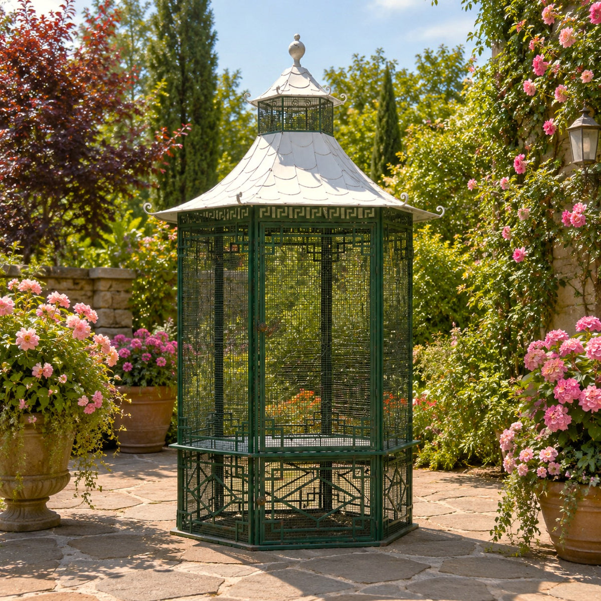 Dark green gazebo with an ornate pale roof, shown closed on a garden patio.