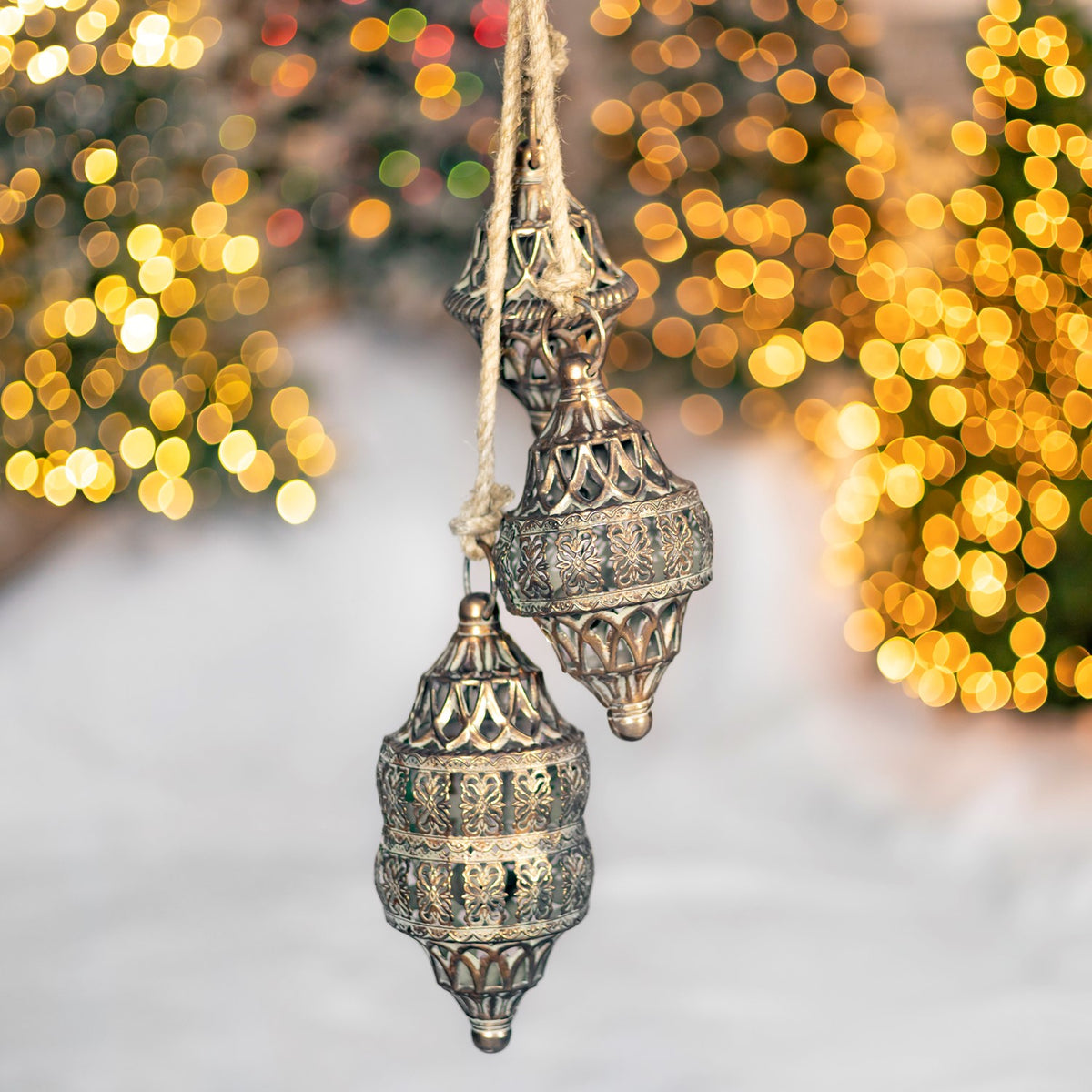 Two ornate gold-toned hanging pieces with pierced latticework and patterned bands.