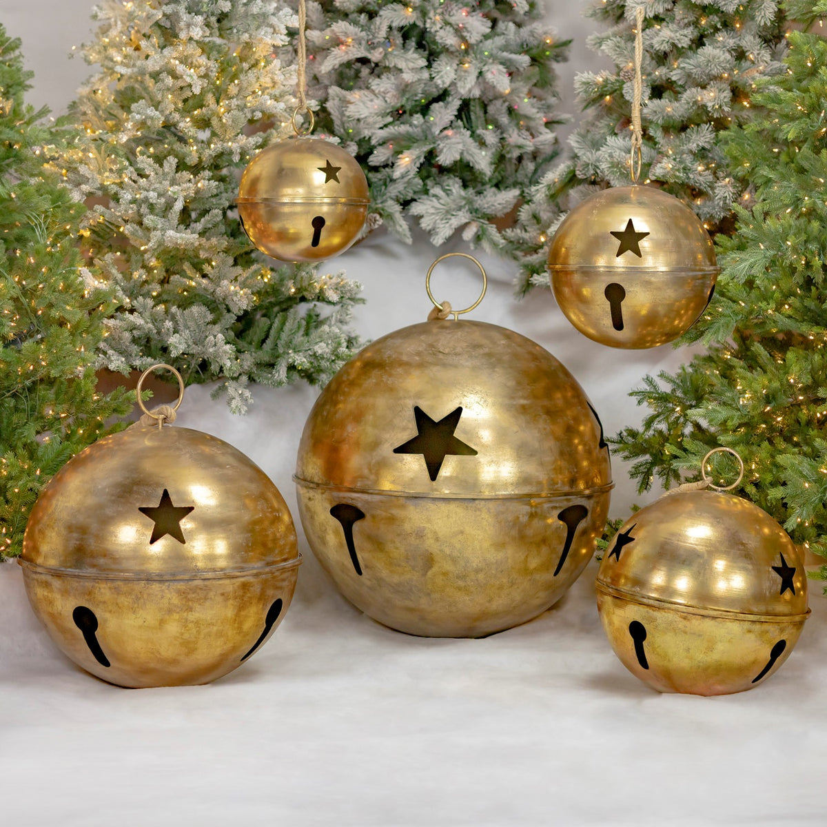 A second arrangement shows five gold bells with star-shaped cutouts against snowy tree branches.