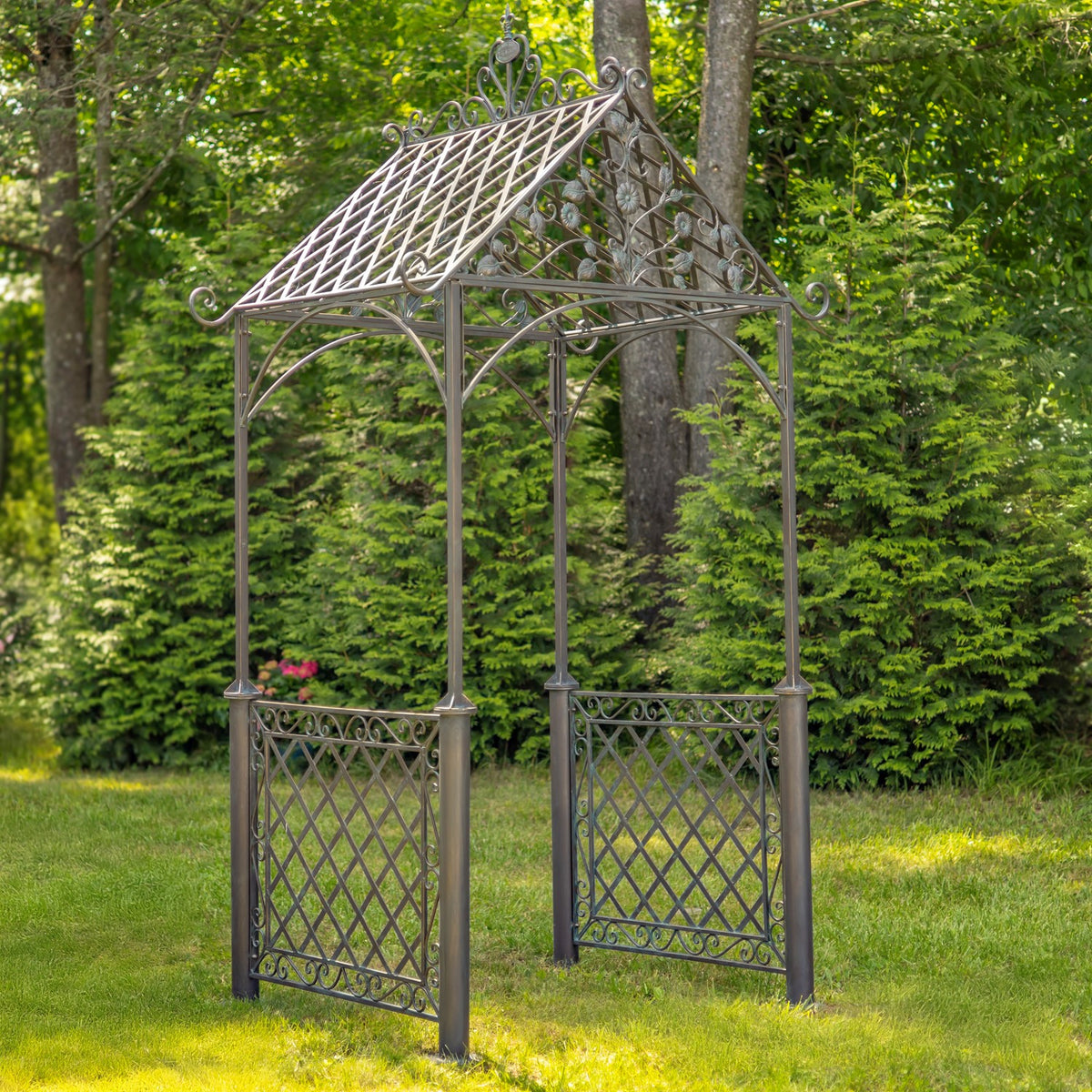 Iron arch from the opposite angle, with a peaked open roof and matching trellis panels on both sides.