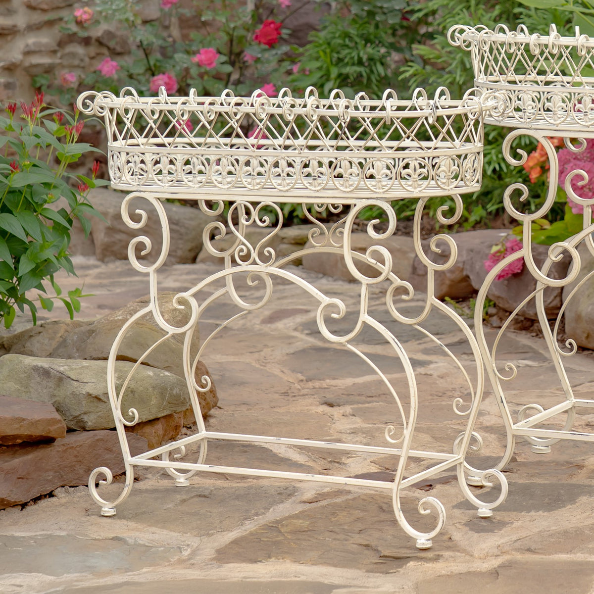 Close view of a white oval basket and curled iron legs on one of the plant stands.