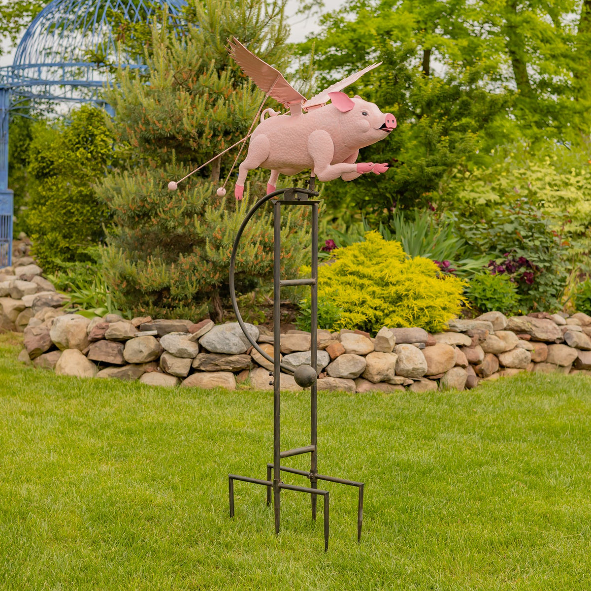 Full view of the pink pig garden stake standing on a green lawn