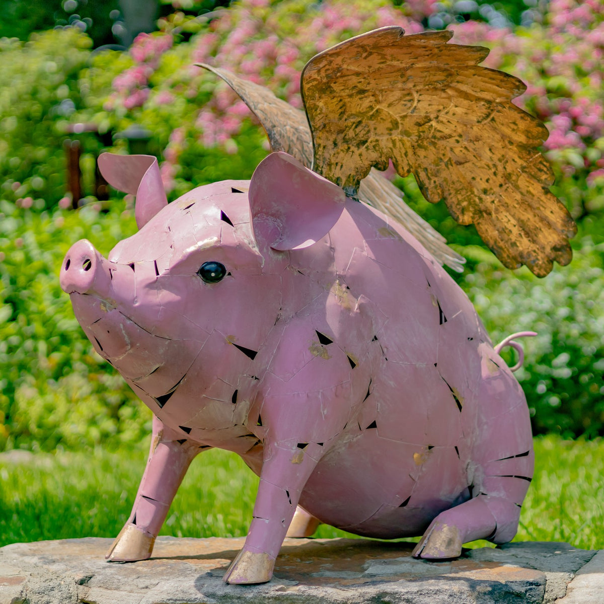 A closer view from the other side shows the pig statue’s face, curled tail, legs, and broad wings.