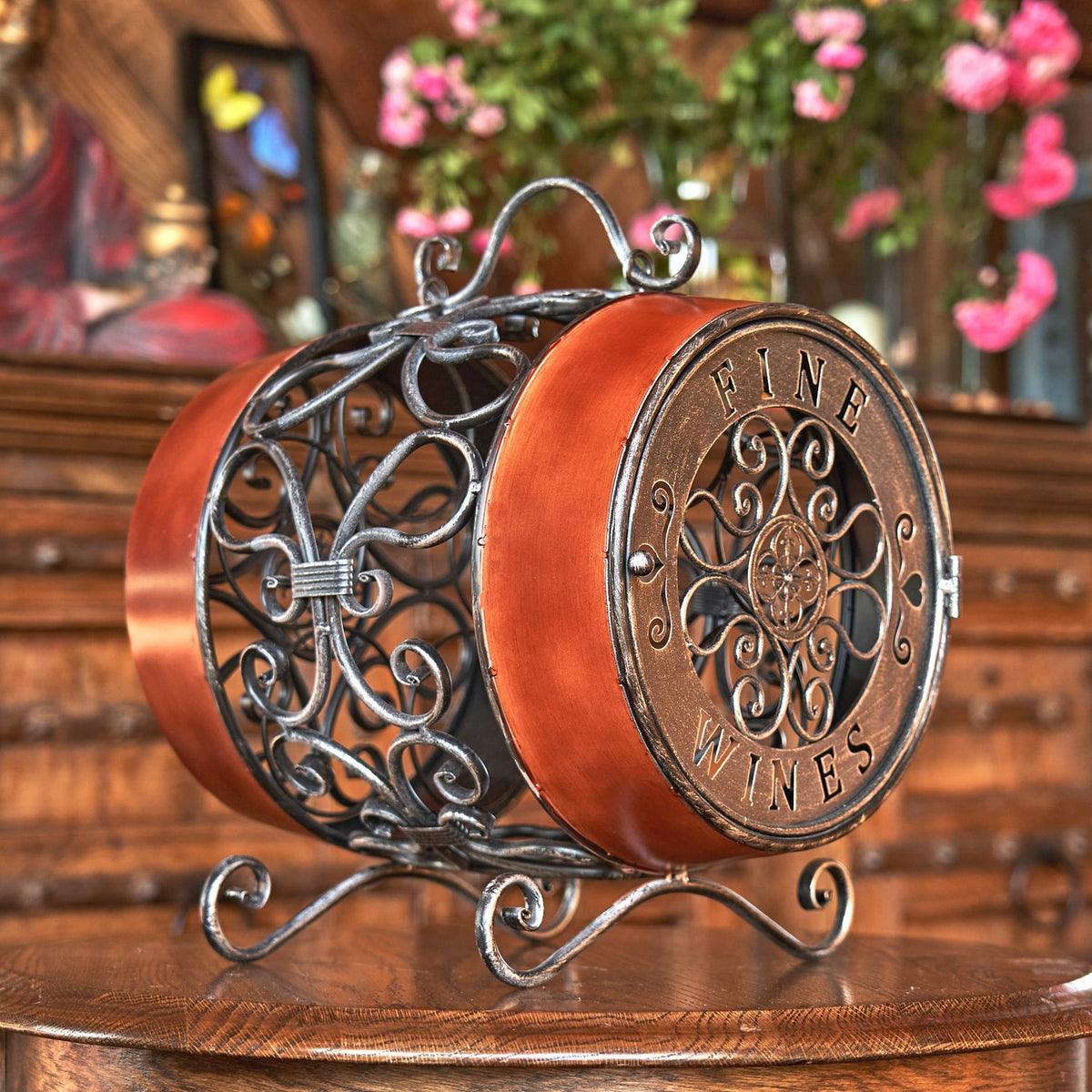 The wine rack from the other side, showing its circular decorative end, metal handle, and open scrollwork frame.
