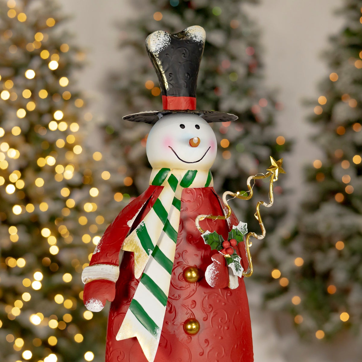 Red-coated snowman with a striped scarf, gold buttons, holly and a curled wire star.