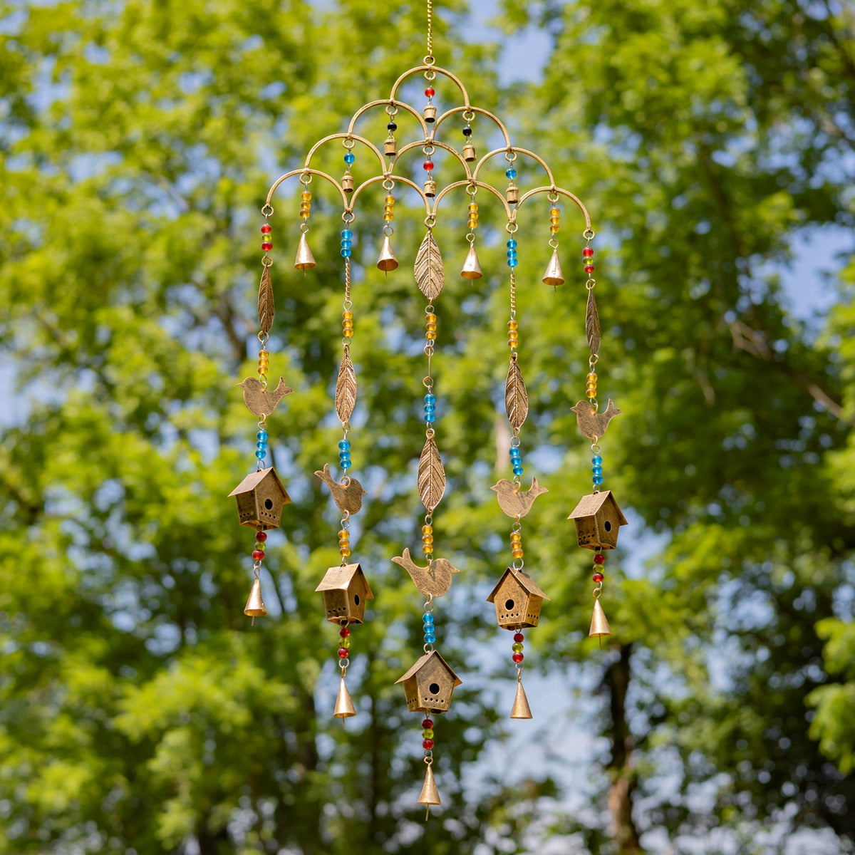 Hanging gold-tone chime with curved tiers and colorful beads, bird accents and small birdhouses.