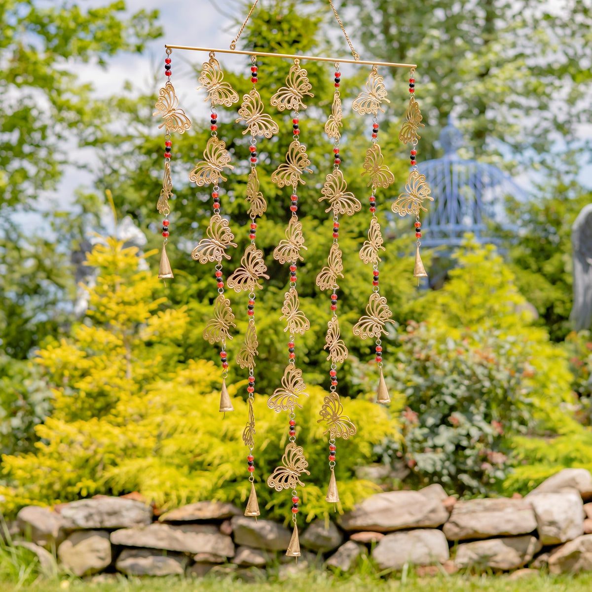 Gold-toned hanging chime decorated with openwork butterfly shapes, colored beads, and small bells.