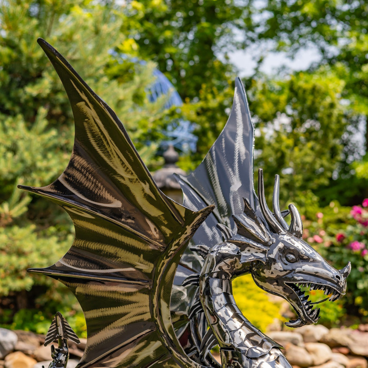 Close view of the dragon’s open jaws, spiked head, and broad ridged wings