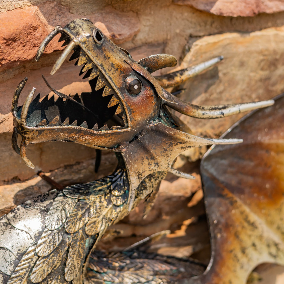 Close-up of the dragon’s open jaws, pointed teeth, horns, and textured scales.