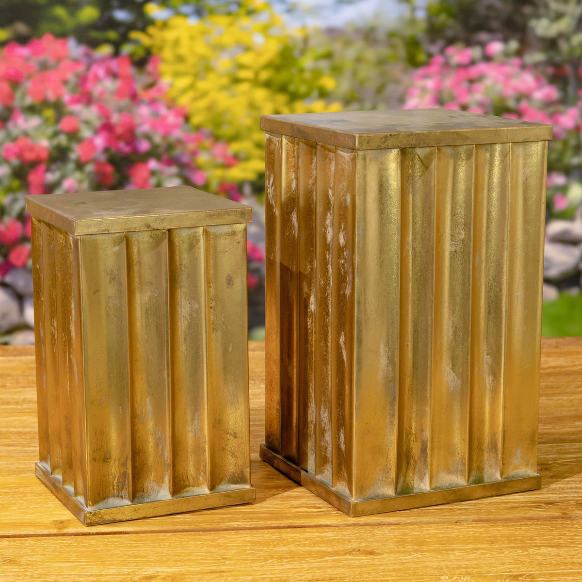 A second angle of the two fluted pedestals, showing their textured golden-bronze finish.