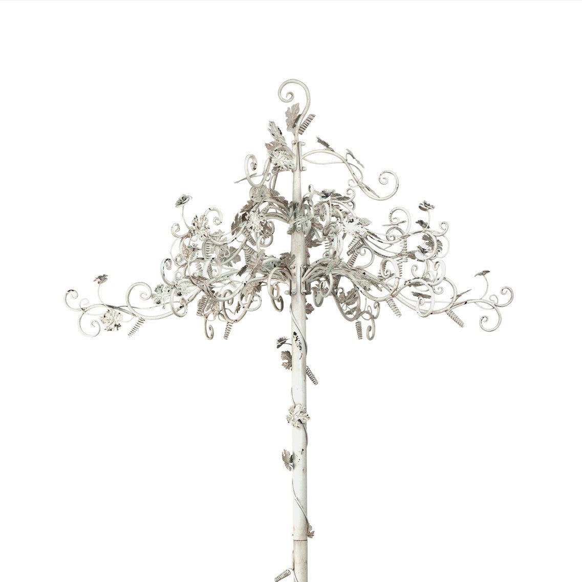 Close view of the white display tree’s ornate curling branches, leaves, and flower accents.