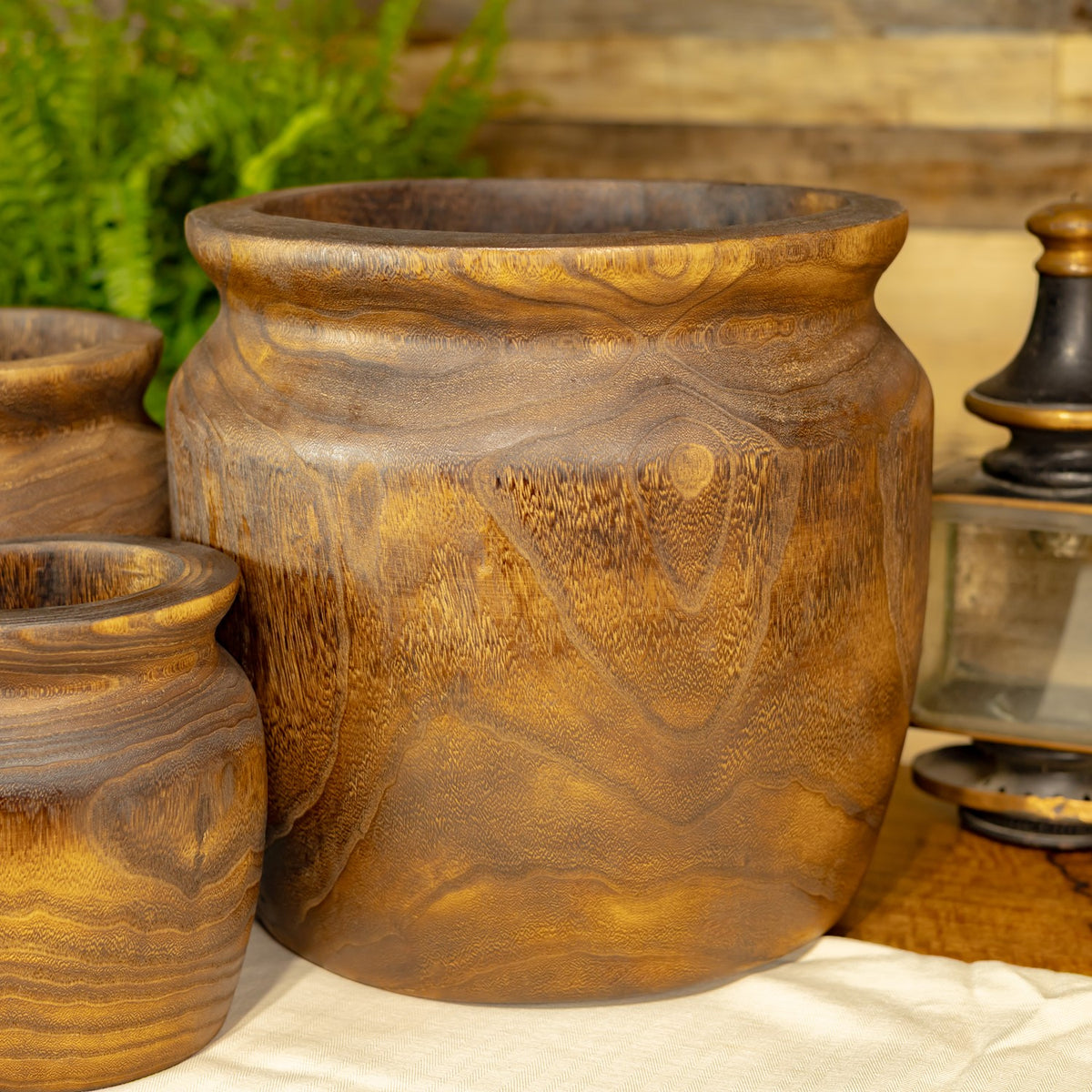 Large round planter with a flared rim and swirling brown wood-grain pattern.