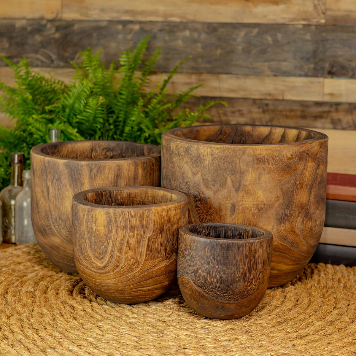 Four empty wooden bowls arranged together, showing their varied sizes and grain.