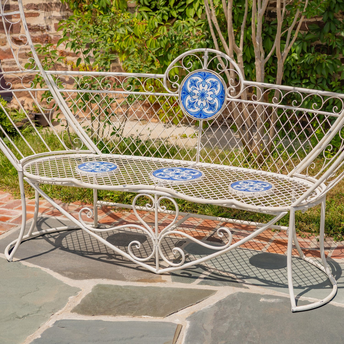 Angled view of the heart-back bench, showing its lattice seat and three blue mosaic insets.