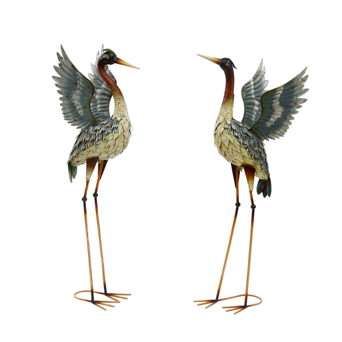 Two metal heron sculptures stand side by side against a white background, both with raised wings.