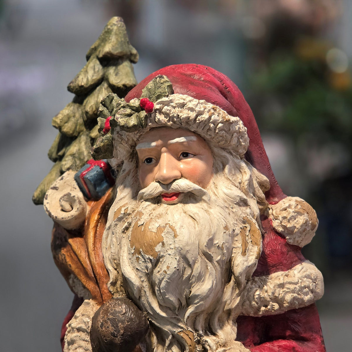 Close-up of Santa's face and decorated tree in a multicolor finish
