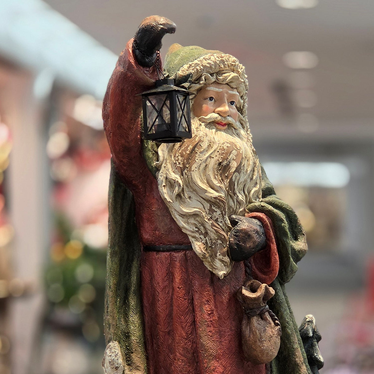 Close front view of Santa's lantern, red robe and detailed beard