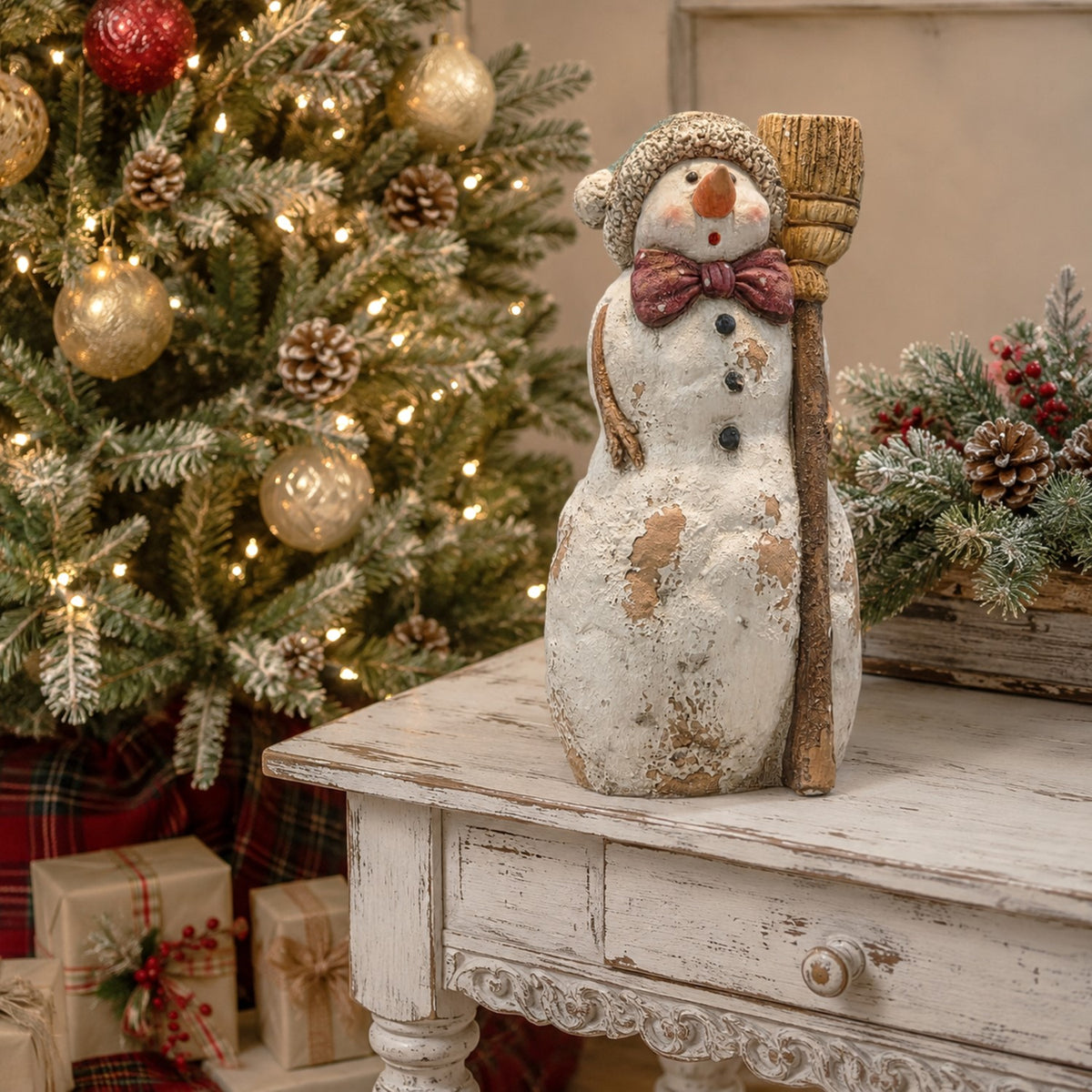 Front view of a distressed snowman holding a broom on a white table