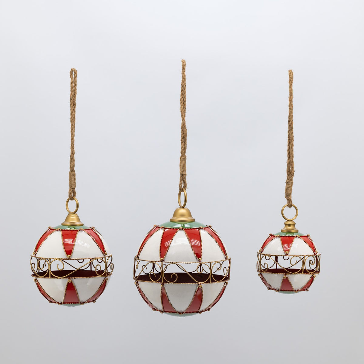 Three hanging ornaments with red and white panels, gold scrollwork, and long rope loops.
