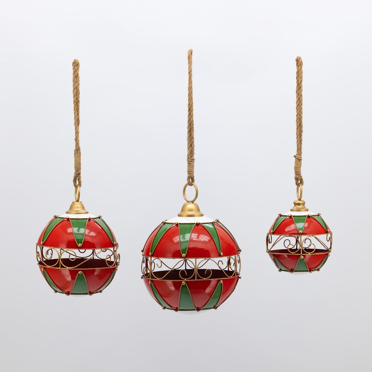 Three red and green spherical ornaments hang against a plain light background.