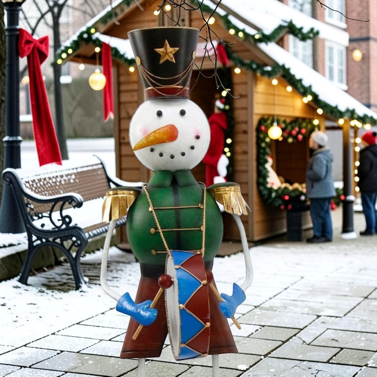 A snowman soldier in a green uniform and tall star hat stands beside a decorated bench.