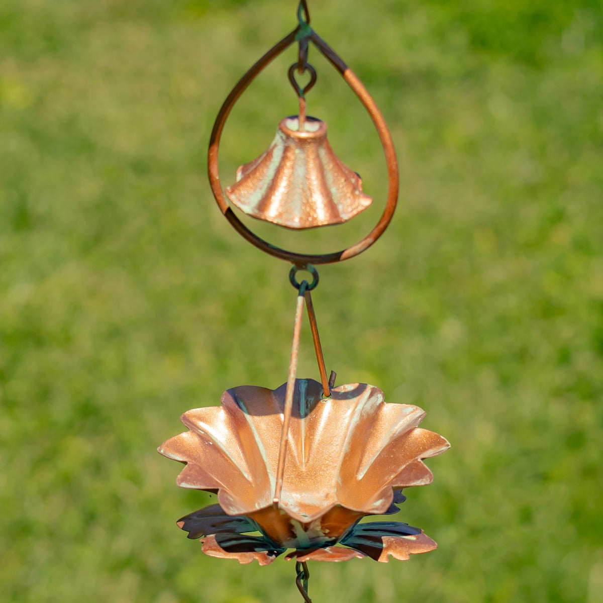 Close view of a flared bell above a layered lotus cup on the hanging chain.