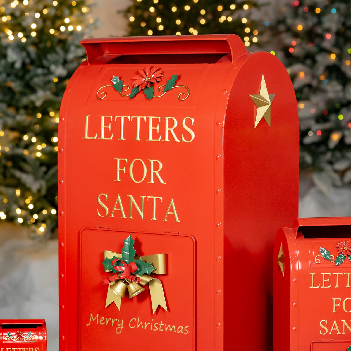 Large red mailbox with gold lettering and holly detail, shown beside smaller sizes