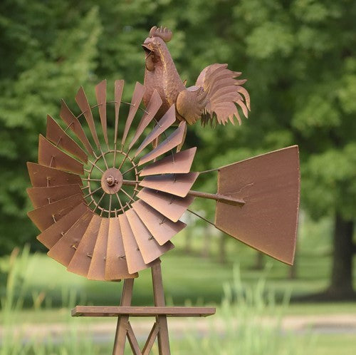 Close view of the rooster ornament, radial windmill blades and broad tail vane.