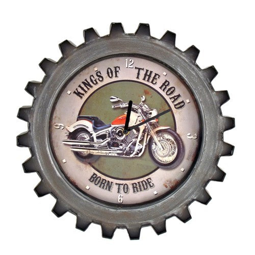 A gear-edged clock showing a red-and-white motorcycle against a muted green center and pale dial.