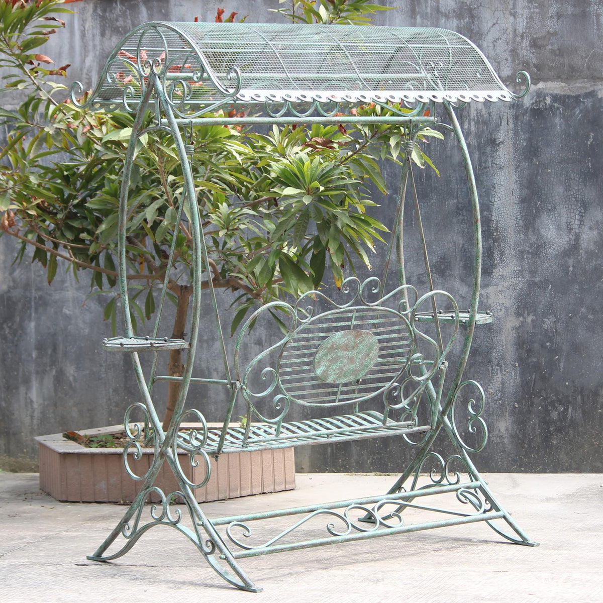 Angled view of the complete swing bench, showing its curved canopy, hanging seat and decorative base.