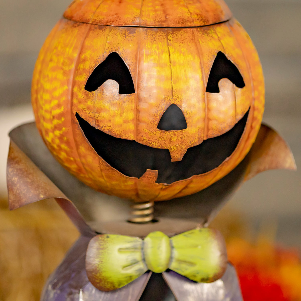 Close-up of the carved-style jack-o-lantern face and green bow