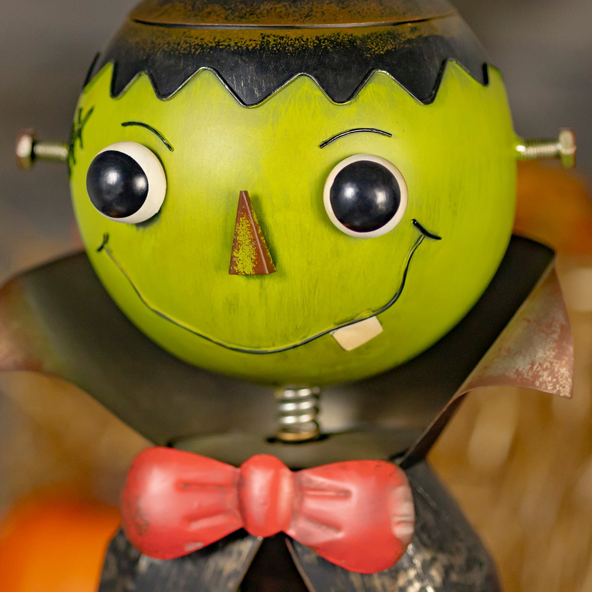 Close-up of the monster's green face and red bow tie