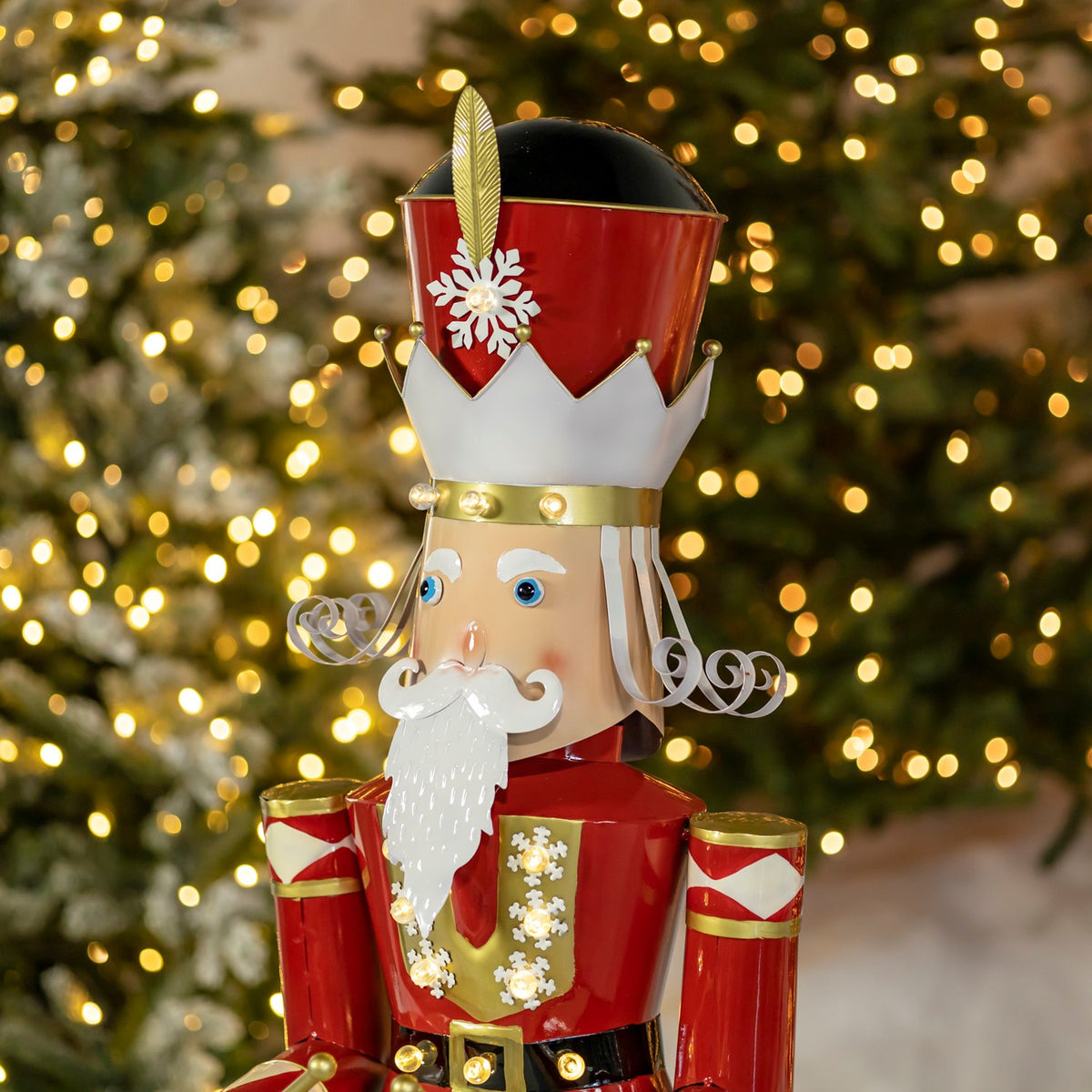 Close-up of the nutcracker’s tall hat, painted face, curled mustache, beard, and decorated red jacket.