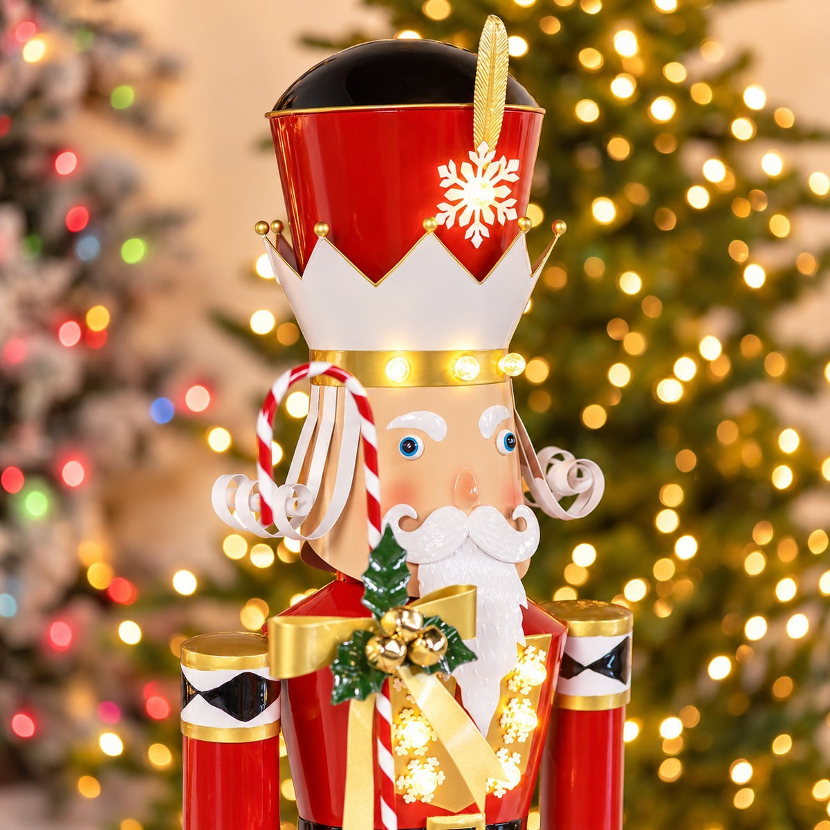 Angled close-up of the nutcracker’s crown, curled mustache, gold bow, and glowing coat.