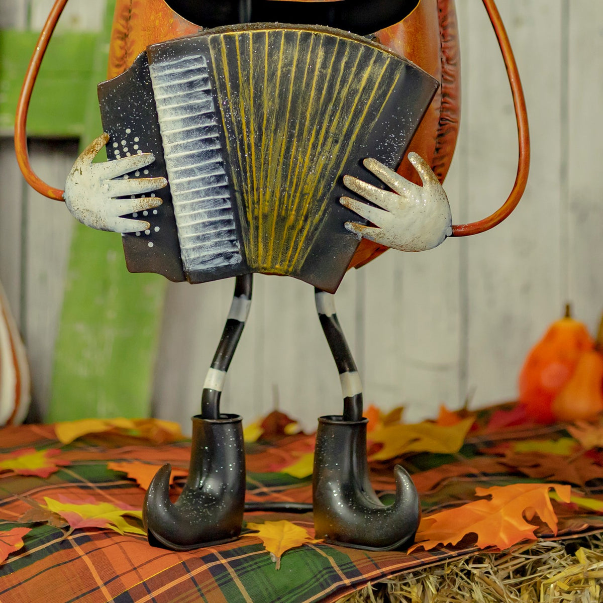 Close-up of the figurine's accordion, hands and curled black boots