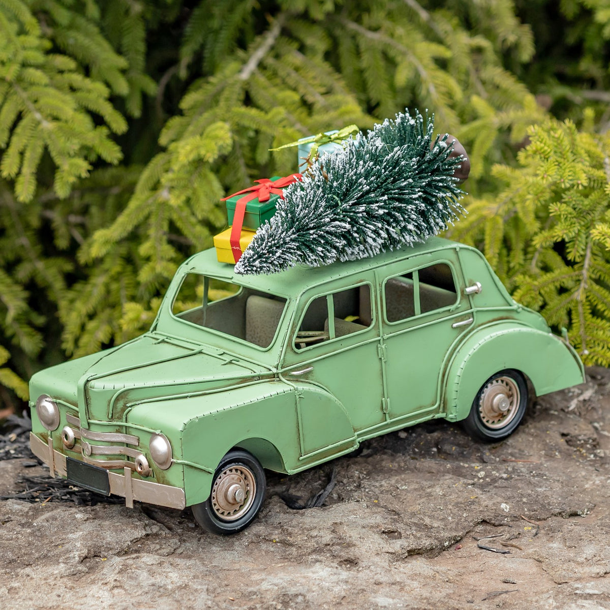 Light green Christmas car with roof decorations viewed from the opposite front angle