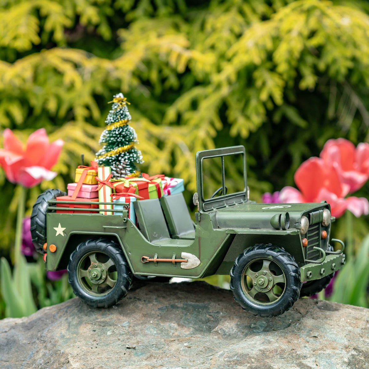 Army-green military vehicle with Christmas tree and gifts, full side view