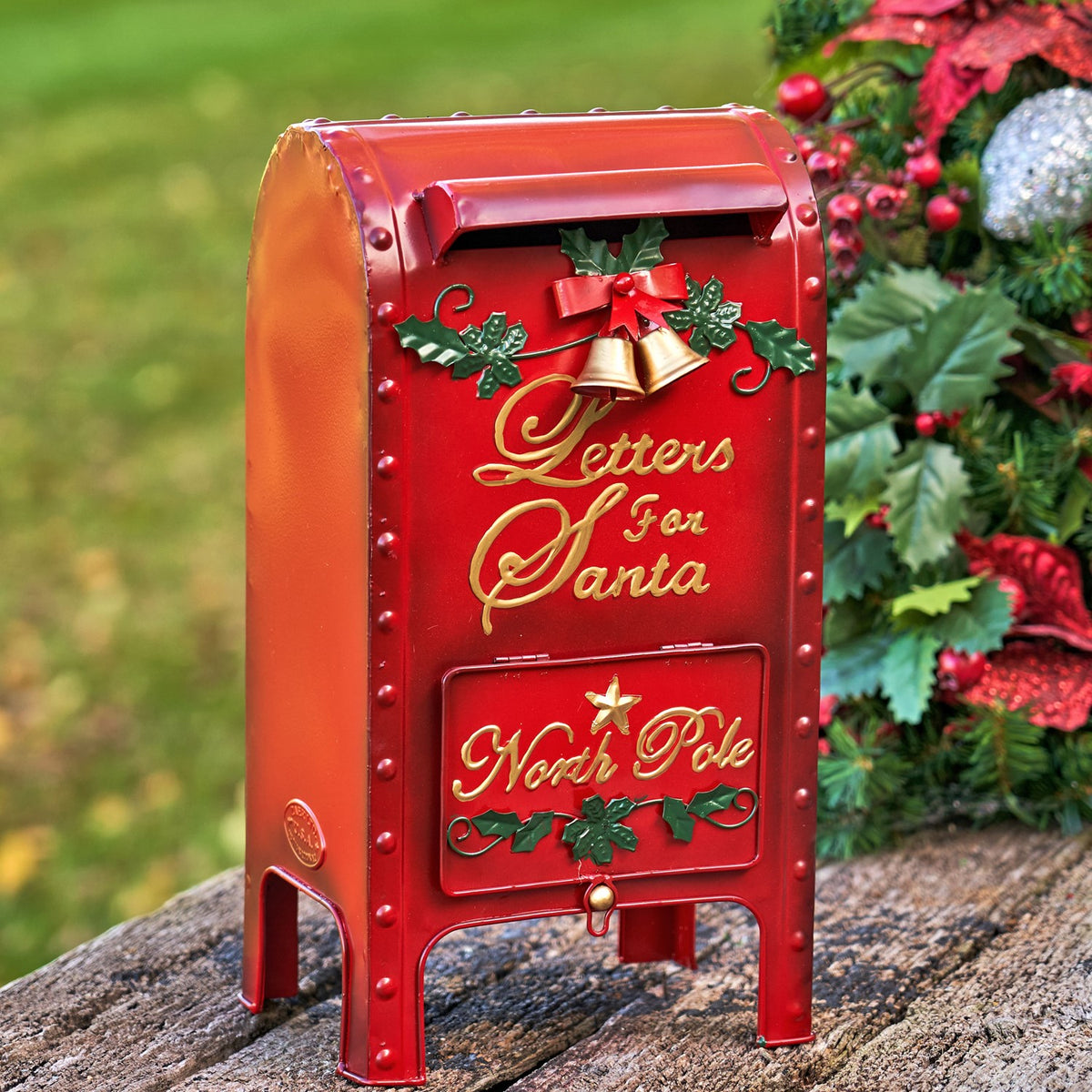 Red mailbox shown from the front, with a letter slot, bell, holly accents, and raised lettering.